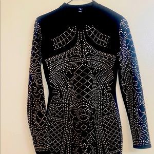 Black long-sleeved mock neck dress from Windsor. Gold detail with zipper back.